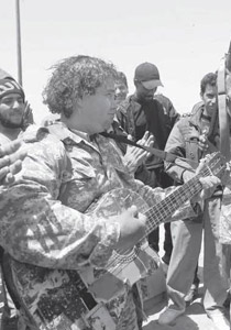 عازف غيتار ومقاتل ليبي يغني لثورة ليبيا في ساحات المعارك!! صورة رقم 1 عازف غيتار ومقاتل ليبي يغني لثورة ليبيا في ساحات المعارك!! صورة رقم 1