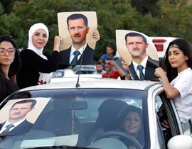 مسيرة في دمشق احتفالا بميلاد الاسد صورة رقم 1