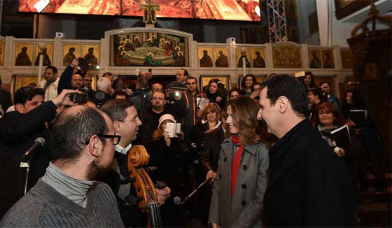 صور الاسد وعقيلته خلال زيارتهما لكنيسة خلال الاحتفال بالميلاد صورة رقم 3